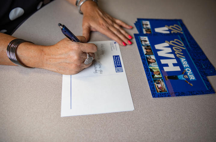 Staff members write handwritten letters to future students.