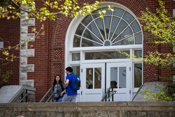 Students talk on the steps of Miller Hall.