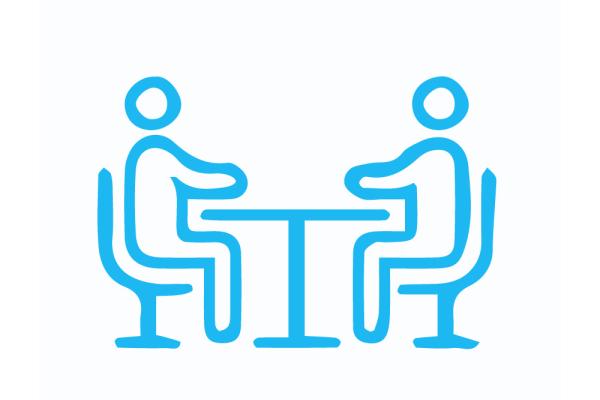 Two people meeting at a table icon