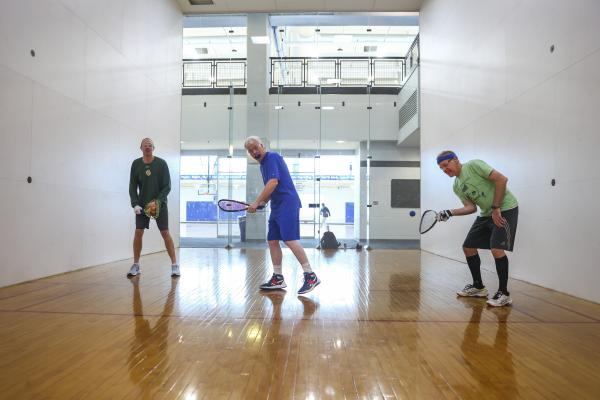 Alumni playing racquetball at the Johnson Center