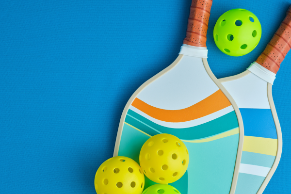 Adobe image of pickleball paddle and balls