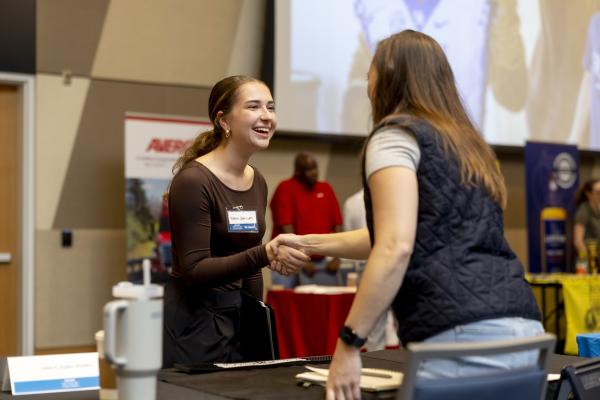 Student shaking hands with an industry representative