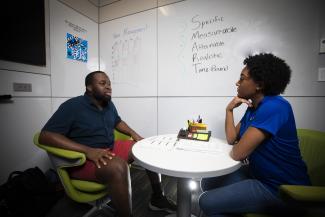 Students talking at a desk