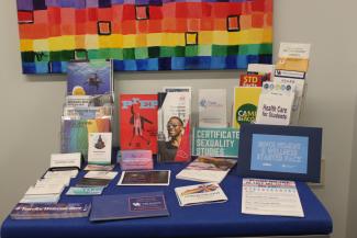A table of campus and off-campus resource flyers for students.