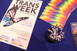Trans Week of Awareness Flyer and promotional pens on a table