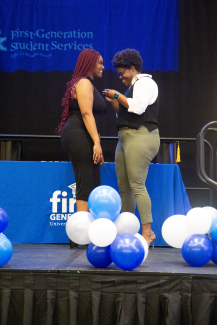 Staff pinning a first-generation student