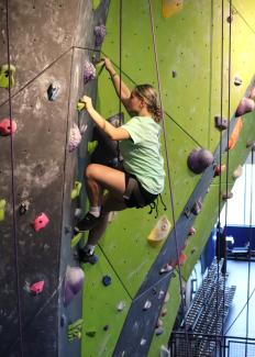 4H participant climbing wall