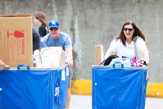 Parents help move in their freshman into Holmes Hall on August 15, 2025.
