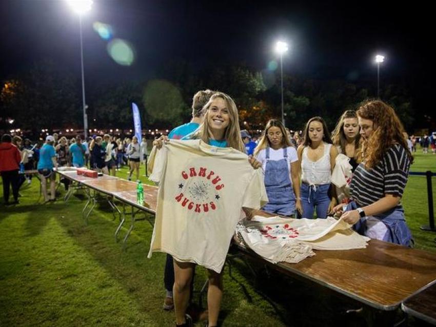 A student shows off the Campus Ruckus 2019 t-shirt.