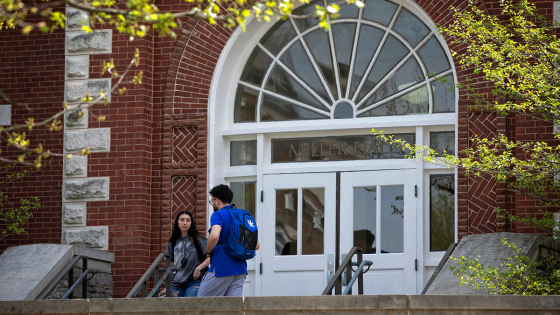 Students talk on the steps of Miller Hall.