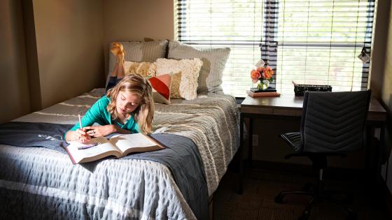 student studying in bedroom
