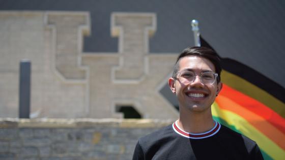 student with pride flag