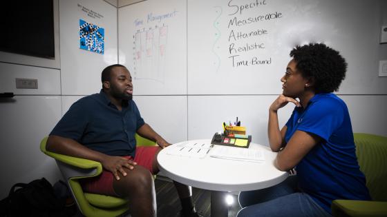 Students talking at a desk