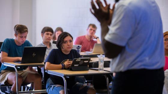 Individual speaking with students