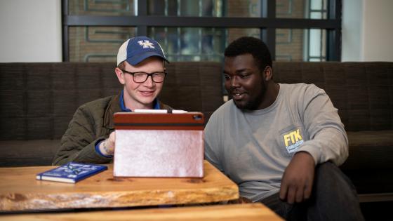 Two male students looking at something on an iPad