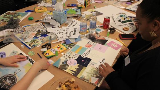 Students sitting at a table during a vision board workshop