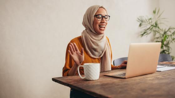 Woman says hello in online meeting