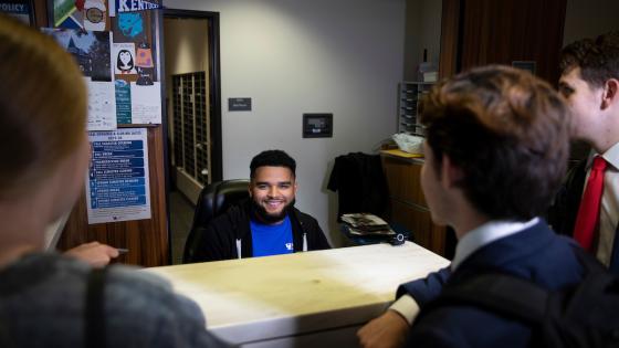 Front desk staff worker helping other students