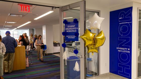 Photo of a door opening to people enjoying the Center of Student involvement located in the Gatton Student Center. 