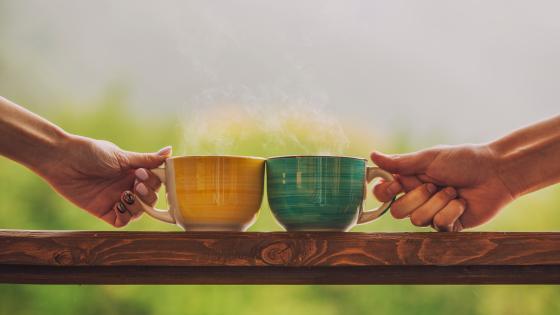 hands holding tea cups