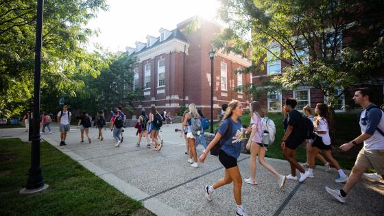 Students on a college campus walking on outdoor walkways.