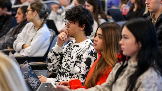 Students in a lecture-style classroom looking forward.