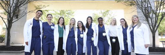Group of healthcare students smiling for a photo in front of 