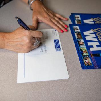 Staff members write handwritten letters to future students.