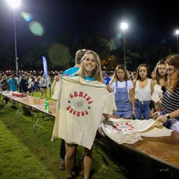 A student shows off the Campus Ruckus 2019 t-shirt.