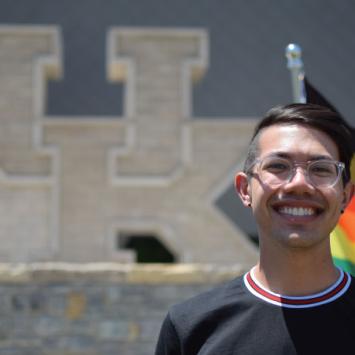 student with pride flag