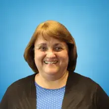 brown hair female with black jacket and blue shirt