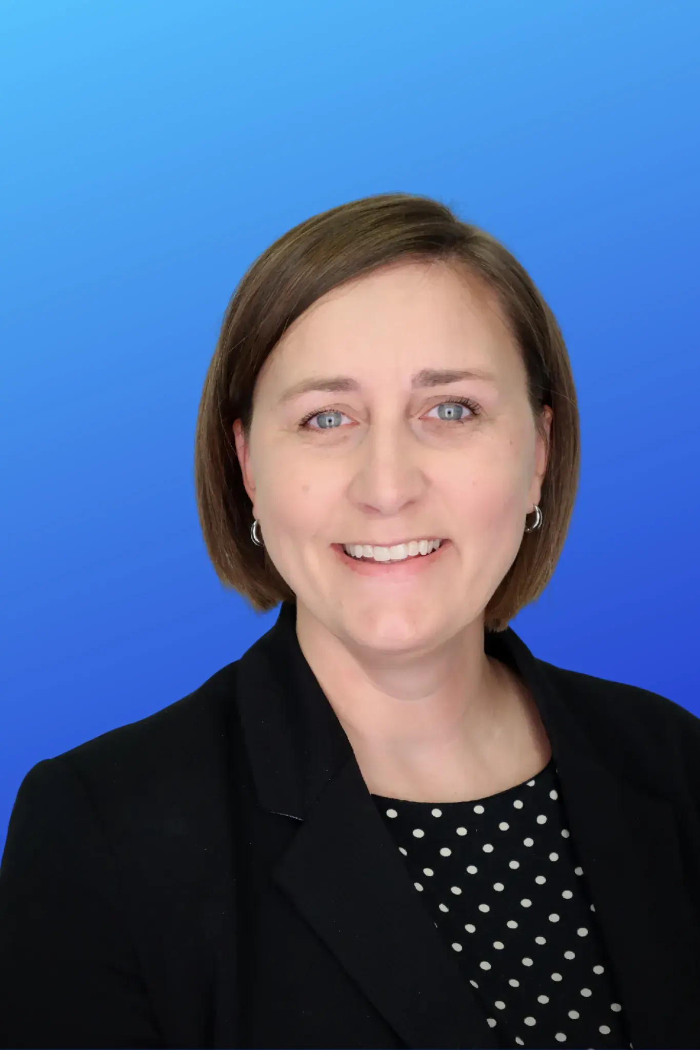 female short brown hair with dark blazer and polka dot top